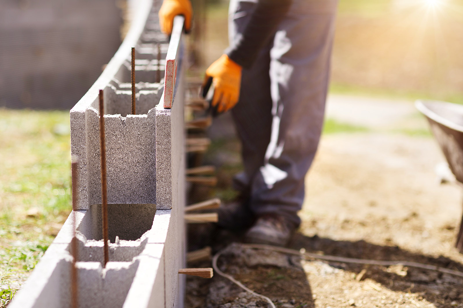 worker laying concrete blocks